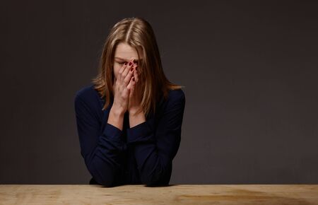 woman with closed hands face. shes in a bad mood
