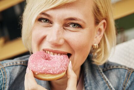Beautiful woman eating chocolate cake at cafeの写真素材