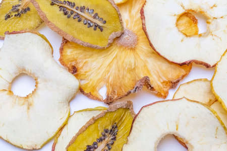 Top view fruit chips (apples, pineapple and kiwi)in on a white background. Close up dried fruits. Healthy eating conceptの写真素材