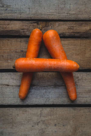 Top view Letter A   carrots on wooden boards.Background with with vegetables with copy space.Vitamin...