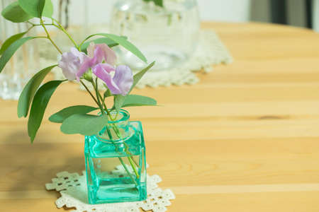 Cute little jug with eucalyptus leaves and sweet peas.