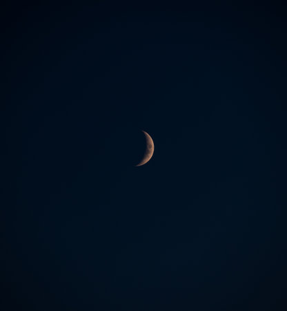 Crescent moon in a deep blue night sky
