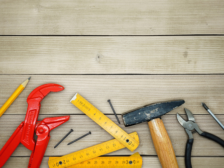 Under Construction - Do It Yourself - Handyman Tools on a Wooden Background