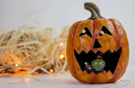 halloween pumpkin with raffia and orange lightsの写真素材