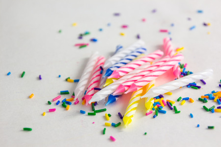 birthday candles with sprinkles on a white backgroundの写真素材
