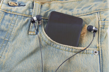 Phone in a back pocket of a denim jeans as a backgroundの写真素材