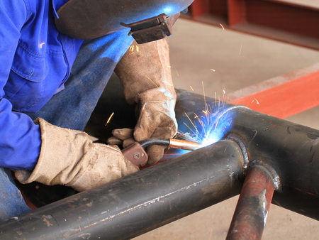 welder is welding pipe structure with all safety, Shown good welds