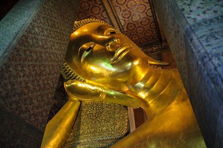 Reclining Buddha gold statue face  Wat Pho, Bangkok, Thailandの写真素材