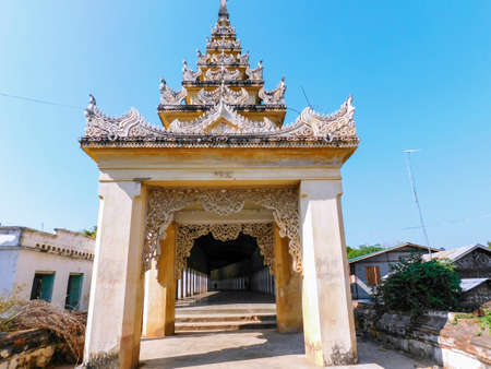 Entrance to the long curved and shady passageway, that leads to the famous Shwezigon Pagoda in Nyaung U, Burma.の写真素材
