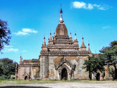 A well preserved ancient Bhuddist temple in Old Bagan features several, parasol topped turrets surrounding the main brick stupa.の写真素材