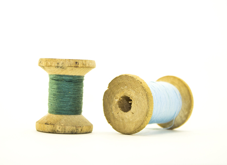 Reel or wood spool of sewing thread isolated on white. Close-up macro shot.の写真素材