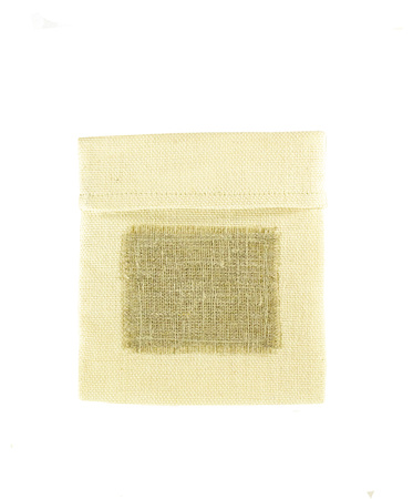 Pouch, pack of coarse fabric, with a blank label. Bag from a sacking isolated