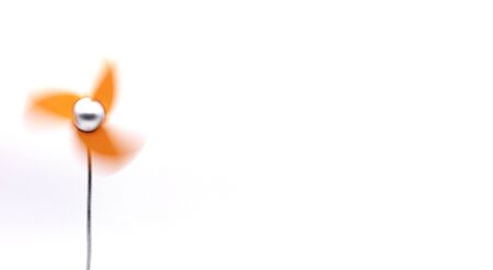 Orange small household fan on a white wall background. Modern design, minimalismの写真素材