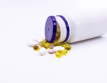 A jar of vitamins on a white background. A bottle of pillsの写真素材