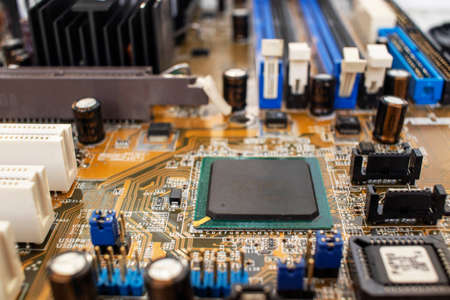 Electronic circuit board with processor, close up. The outdated model of computer