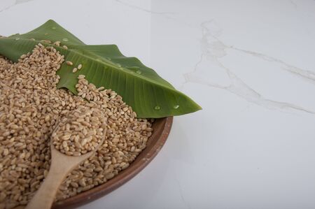 wheat grain on plate with banana leaf. Natural food healthy with wheat seed. Wheat gain put on the...