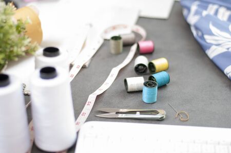 Set of Tailor accessories.Sewing accessories and fabric. Fasion Design online working place. Sewing colored threads. Fashion Design working studio. Fashion Industry. の写真素材