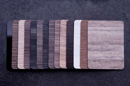 Materials Concept. Top view of wood laminate materials on wooden floor. Interior materials design for home and renovation building. Surface Color Texture of laminate; veneer; parquet; plywood and vinyl floor for Interior designer. Wallpaper for furniture background.の写真素材