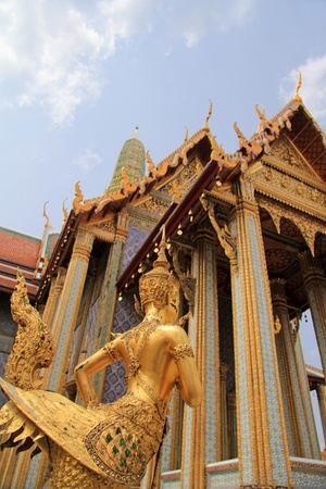 Golden statue of a Kinnara guarding Wat Phra Kaew, Bangkok, Thailandの写真素材