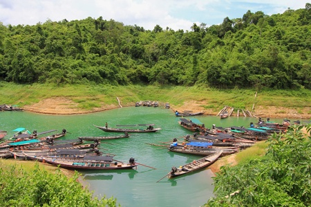Surat Thani, Thailand - 7 June 2013   Captains waiting for tourists at the long-tail boat pier at Ratchaprapa  Chiao Lan  Dam, Surat Thani Province, Thailand のeditorial素材