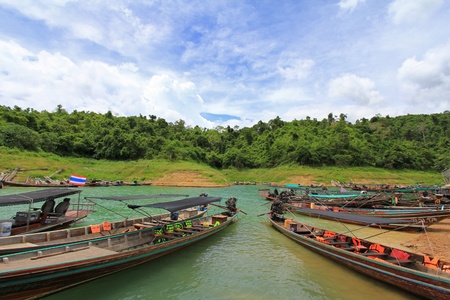 Surat Thani, Thailand - 7 June 2013   A group of boats waiting for tourists at the long-tail boat pier at Ratchaprapa  Chiao Lan  Dam, Surat Thani Province, Thailand のeditorial素材