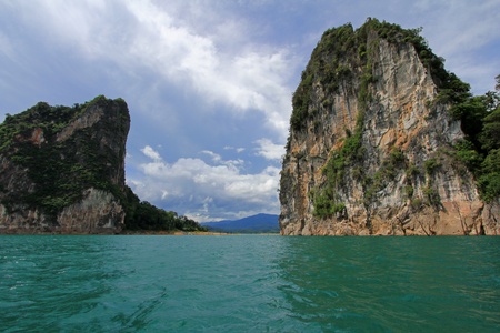 Cruising on the long tail boat to enjoy Limestone scenery in Ratchaprapa Dam, Surat Thani province,...