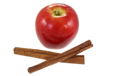 Cinnamon sticks and fresh Red Apple, isolated on white backgroundの写真素材