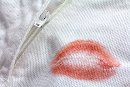 Stain of Red Lipstick kiss near a zipper on a white pantsの写真素材