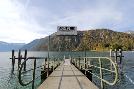 TYROL, AUSTRIA - OCTOBER 2013    A pier for boat trips on Achensee Lake during Autumn on October 20, 2013 in Tirol, Austria  The Achensee is the largest lake within the federal state, and has a maximal depth of 133 metres のeditorial素材