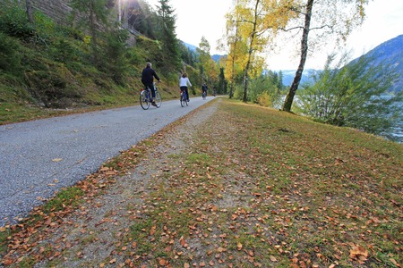 TYROL, AUSTRIA - OCTOBER 2013    People riding a Bicycle along the Achensee Lake during Autumn on October 20, 2013 in Tirol, Austria  The Achensee is the largest lake within the federal state, and has a maximal depth of 133 metres のeditorial素材