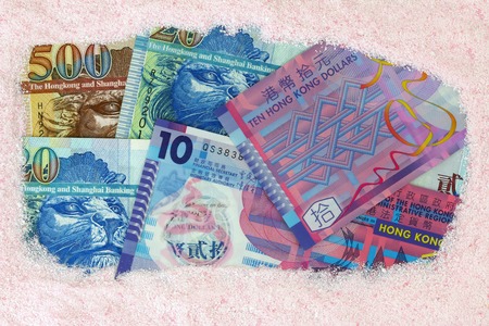 Money laundry   Hong kong dollar banknotes under pink Laundry washing powderの写真素材