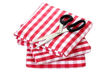 Folded fabric, gingham pattern, with a pair of scissors on it