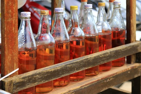 Gasoline in whisky and syrup bottles on Koh Lanta Island in Krabi, Thailand. These bottles can be seen in urban areas in Thailand and it is convenient to motorcyclists.のeditorial素材