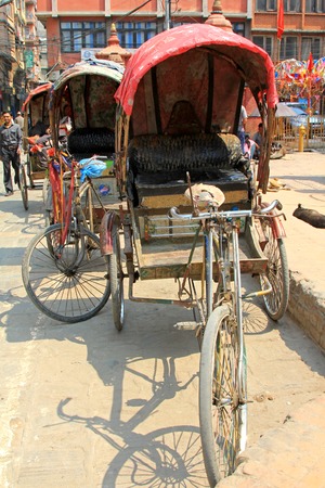 A group of 3 wheeled rickshaws waiting for customers in Kathmandu, Nepalのeditorial素材