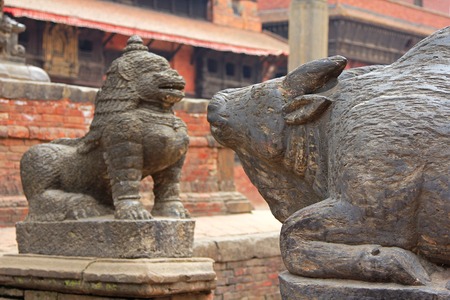 PATAN, NEPAL - APRIL 2014 : A statue of cow and snow lion at Patan Darbar Square on 13 April 2014 in Patan, Nepalのeditorial素材