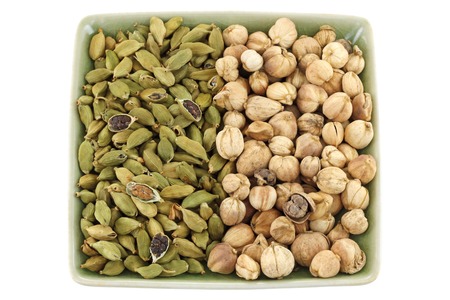 Dried green Cardamon pods and Round Siamese Cardamom (Camphor Seed) isolated on white