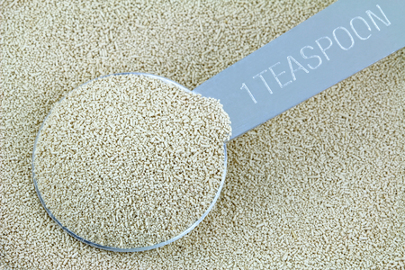 Closeup of a spoonful of active dry Baking yeast granulesの写真素材