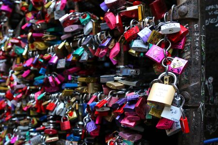 A metal gate full of colorful locks at Juliet's house Casa Capuleti in Verona, Italy on September 13, 2014. Romeo and Juliet is a tragedy written by William Shakespeare.のeditorial素材