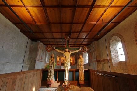 The Crucifixion scene, circa 1330, with Christ on the Cross and 2 figures of Mary and John in attendance at Tyrol Castle Schloss Tirol in the Burggrafenamt district of South Tyrol, Italy on 19 october 2013.のeditorial素材