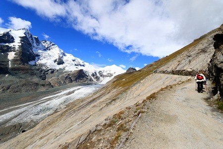 Hikers walking on a Gamsgrube Nature hiking trail along the Pasterze Glacier at Grossglockner, Hohe Tauern National Park, Austria on September 16, 2014. Pasterze Glacier is the longest mountain glacier in Austria at approximately 8.4 kilometers in length.のeditorial素材