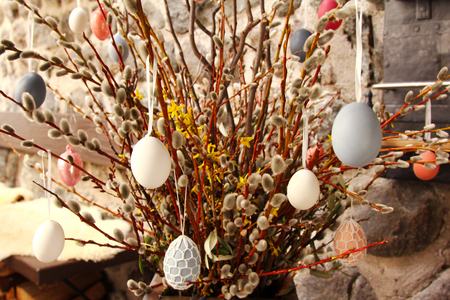 Decorative eggs hanging on dried Pussy Willow branches during Easter
