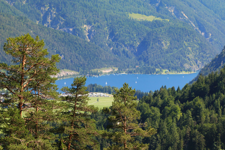 Landscape view of the Achensee Lake Achen surrounded by mountains and forests in Tirol, Austriaの写真素材