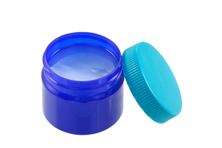 A small blue green jar full of mentholated topical ointment isolated on white A small blue green jar full of mentholated topical ointment isolated on white