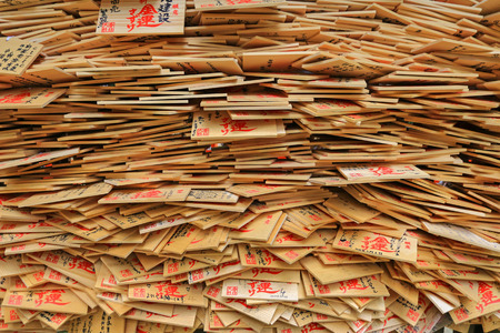 A stack of wooden wishing plaques, prayer tablets called Ema in Japan in Nara, Japan.のeditorial素材
