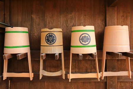 Traditional Japanese plastic and wooden bucket hanging on the wallの写真素材