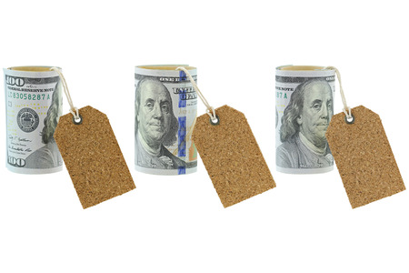 Rolled new United stated 100 dollar banknote with blank natural cork label tags hanging, isolated on whiteの写真素材