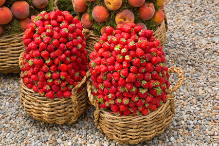 Handmade basket decorate with fresh strawberry and peach.