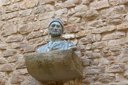 FLORENCE, ITALY - SEPTEMBER 2016 : Bust sculpture of Dante Alighieris head shoulders chest on brick wall at Dante's House in Florence, Italy on September 21, 2016. Dante is Italian poet of the late Middle Agesのeditorial素材