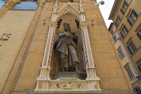 FLORENCE, ITALY - SEPTEMBER 2016 : Bronze statue of St. Luke San Luca, detail of Orsanmichele church exterior with 1 of 14 external niche figures in Florence, Italy on September 21, 2016のeditorial素材