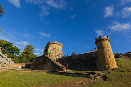 Port Arthur, Tasmania, Australia - April 12, 2017 : Tourists walking up to Guard Tower as a ruin on Settlement Hill at Port Arthur Historic site in Tasmania, Australia on April 12, 2017. It was built in 1842 as military precinct to watch over the siteのeditorial素材